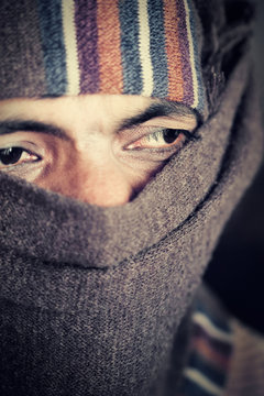 Indian man covered face by woolen scarf