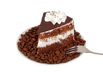 Slice of chocolate cream cake on coffee seed
