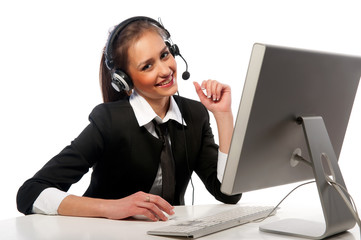 girl with a headset works at the computer
