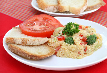 Healthy Quinoa Salad with a side of sliced tomatoes.