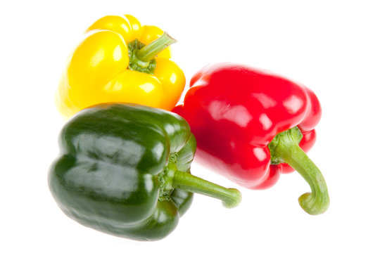 Three red,  green and yellow bell peppers