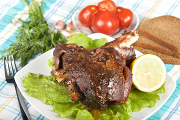 Roast leg of lamb on decorated table