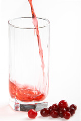 In a glass pours the cranberry juice