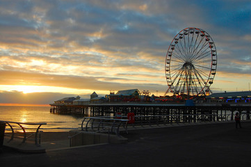An evocative  colourful sunset view of central pier in the popular seaside resort of Blackpool in...