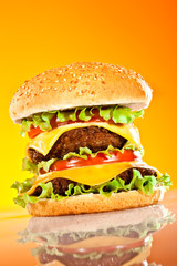 Tasty and appetizing hamburger on a yellow