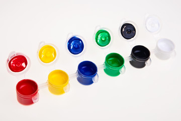 Colorful school water paints isolated over white background.