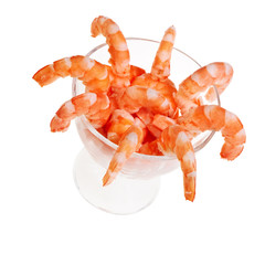 Fresh shrimps in glass cup isolated over white background.