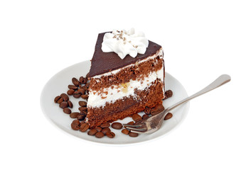 Slice of chocolate cream cake on coffee seed