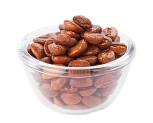 Natural coffee beans heap in transparent glass bowl, isolated on