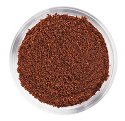 Natural ground coffee heap in transparent glass bowl, isolated o