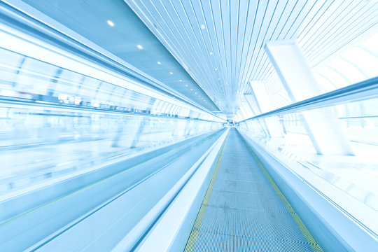 futuristic escalator inside contemporary airport
