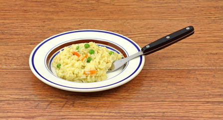 Rice pilaf with fork on wood tabletop