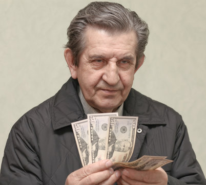 Elderly Happy Man With Pack Of Money