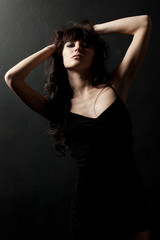 Naklejka premium woman posing wearing black dress
