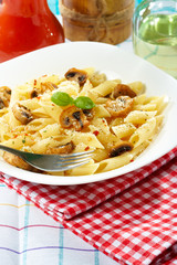 Pasta penne with mushrooms and basil