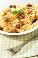 Pasta penne with mushrooms and basil