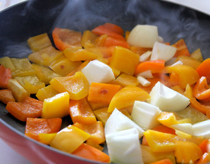 Sweet peppers & onions frying in skillet