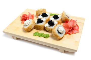 rolled sushi on wooden stand