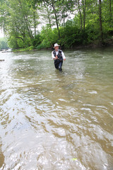 Man fishing trout in river