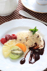 Chocolate chips ice cream with fruit on plate