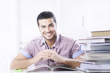 young student smiling with books on white background