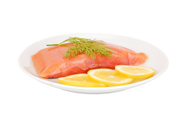 Fresh salmon steak with lemon slice and dill, isolated on white