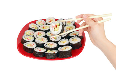 Japanese cuisine - sushi roll and stick in hand on white