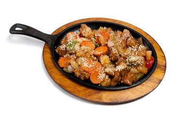 Roasted meat with vegetables on frying pan