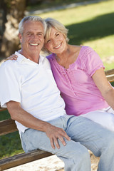 Happy Senior Couple Smiling Outside in Sunshine - obrazy, fototapety, plakaty