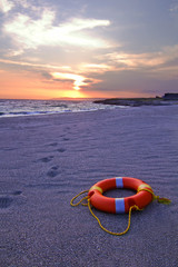 ring buoy lying on the sandy beach