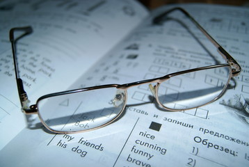 Glasses lay on the book
