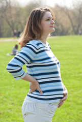 pregnant woman relaxing on the meadow