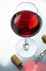 Wineglass with cork and corkscrew