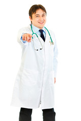 Fototapeta premium Smiling medical doctor pointing finger at you isolated on white.
