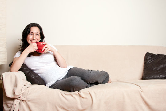 Woman With Drink On Couch