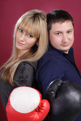 attractive family couple in  boxing gloves on red