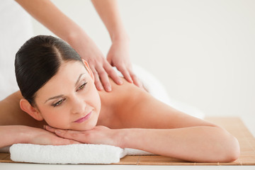 Fototapeta na wymiar Pretty dark-haired woman enjoying a massage