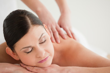 Obraz na płótnie Canvas Lovely dark-haired woman enjoying a massage