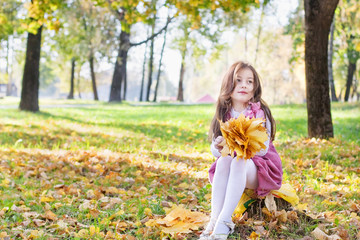 beautiful girl with yellow leaves outdoor