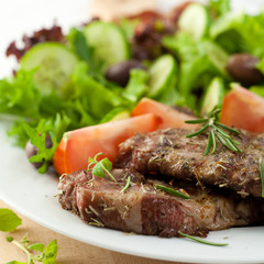 Grilled pork steaks served with salad