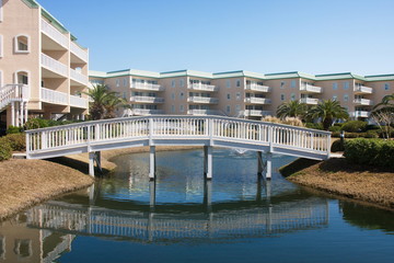 Wood Bridge Over Blue Lagoon in Luxury Condo Complex