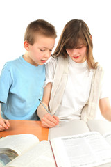 teenage girl and schoolboy on the table with exercise books
