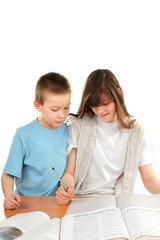 teenage girl and schoolboy on the table with exercise books