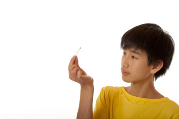 boy looking at burned match