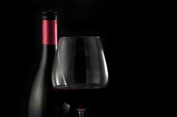 Glass of red wine on black background