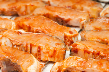 sturgeon filets marinated in tomato sauce
