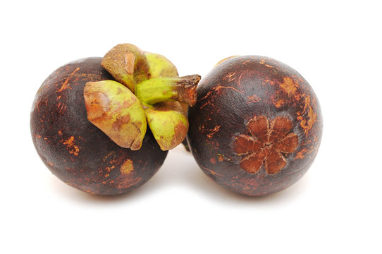 Two mangosteens isolated on white