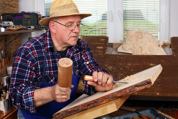 Woodcarver work in his workshop