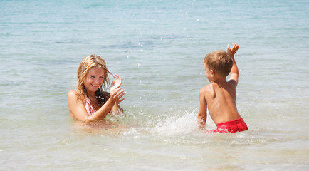 mother and son playing in water