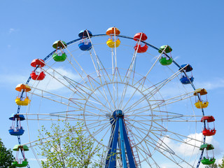 Ferris wheel on blue sky background